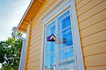 Window of country house. A vintage device for monitoring the street.