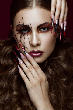 woman in the image of spider with creative art makeup and long nails. Manicure design, beauty face.