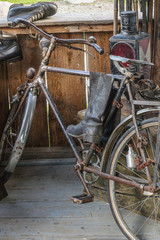 Old bicycle and boots on the porch