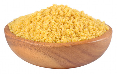 Uncooked italian pasta stars in a wooden bowl on a white