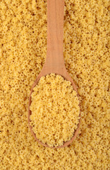 Uncooked italian pasta stars in a spoon