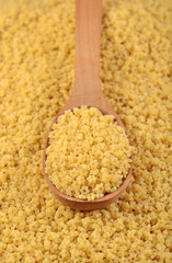 Uncooked italian pasta stars in a spoon