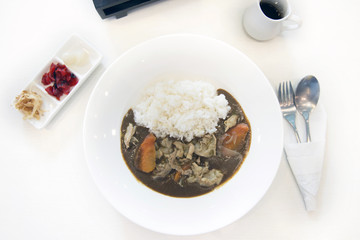 Japanese curry rice with pork, and side dishes.