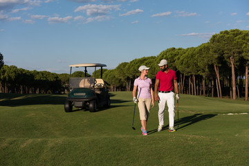 couple walking on golf course
