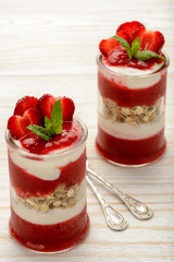 Healthy yougurt dessert with strawberry mousse, muesli and strawberries.