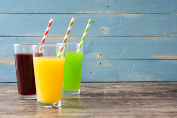 Fresh fruit smoothies on rustic wooden floor and blue wooden wall
