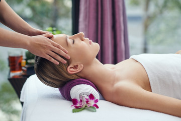 Chinese pretty woman receiving head massage in salon