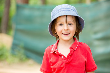 Portrait of a cute little boy in amusement park, having fun