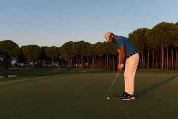 golfer  hitting shot at golf course