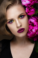 Beautiful girl with colorful make-up, flowers, retro hairstyle. beauty face.