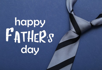 Happy fathers day sign on paper and blue tie