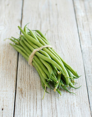Green french beans on wood