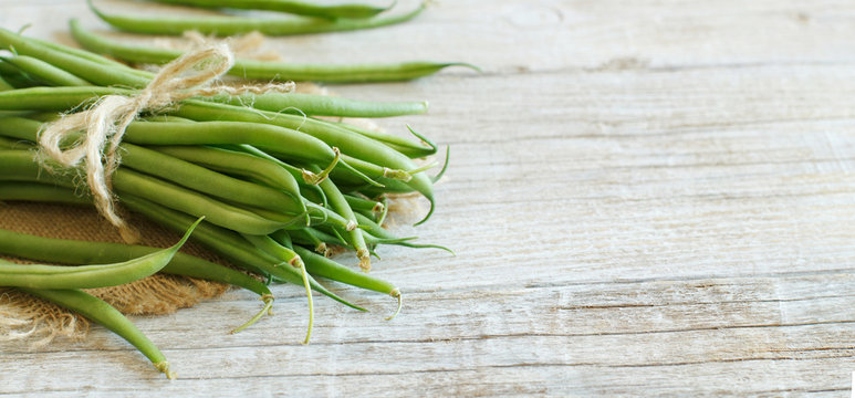 Green french beans on wood