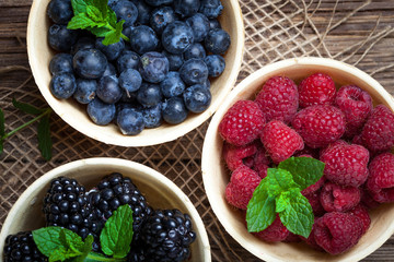 Blackberries, raspberries and blueberries in a waffle bowls.
