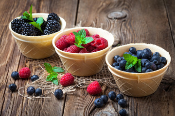 Blackberries, raspberries and blueberries in a waffle bowls.