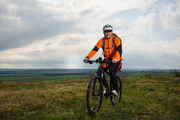 Naklejka premium Young man is riding bicycle outside. Healthy Lifestyle.