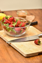 Slicing strawberries on a wooden table