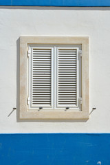 Exterior of wall house with window shutters, Portugal