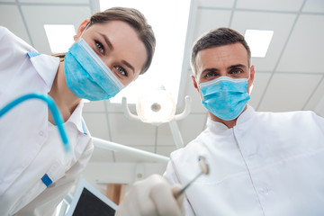 The two dentists in dental office making treatment