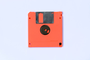 orange colorful floppy disk or diskette isolated on white backgr