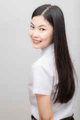 Happy asian student woman in white suit smiling