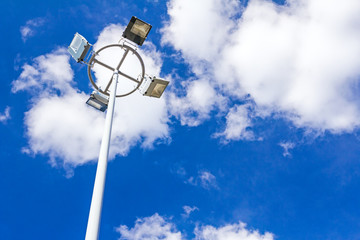 Spotlight tower and cloudy sky