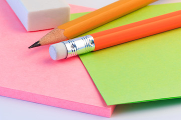 Pencil, eraser and a paper note up close. Simple pencil, eraser and paper note.