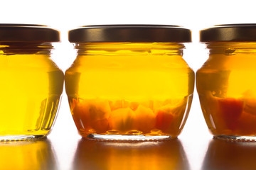 Bright yellow jam - dandelion flower honey in glass jars on whit