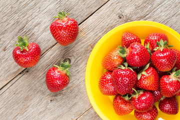 Yellow plate with fresh strawberries