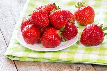 Strawberries  on green and white checkered napkin.