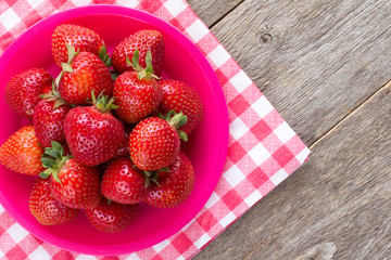 Strawberries on red and white checkered napkin