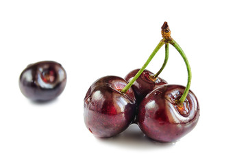 Four berries of sweet cherry on a white hum noise.