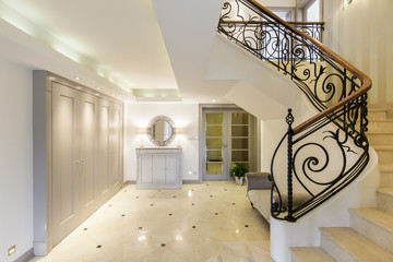 Spacious corridor with stylish staircase