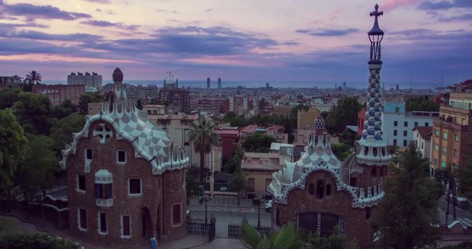 Barcelona landmarks. Morning in Park Guell designed by Antoni Gaudi in Barcelona, Spain. Timelapse of clouds over european city at sunrise. View of travel landmarks in Europe. Modern architecture
