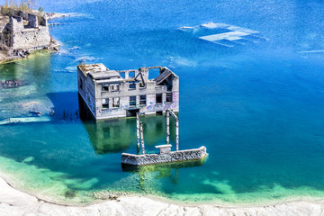 Abandoned sunken ruins of Soviet time prison in Rummu quarry, Estonia. HDR image