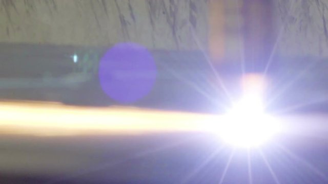 The striking light coming from the plasma cutter with the sizzling sound during the cutting of metal sheet