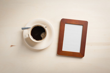 Obraz na płótnie Canvas Photo frame and coffee cup