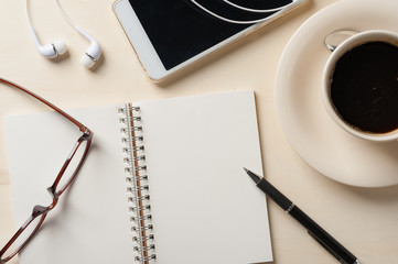 Small notebook and coffee cup