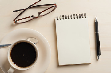 Small notebook and coffee cup