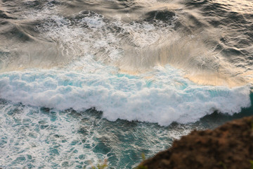 Sea Surf on the Rocky Shore on the sunset