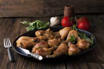 Fried chicken legs with spices, rosemary and mint