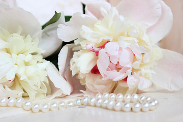pale pink peonies with a necklace of white pearls