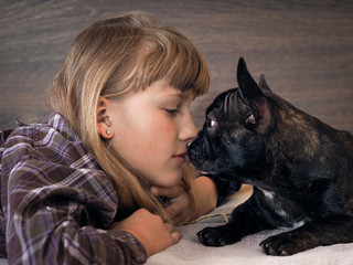 The girl's face and muzzle the dog. Kiss the girl and dog