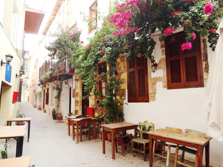 Obraz na płótnie Canvas traditional street among bougainvillaea in chanya city Greece