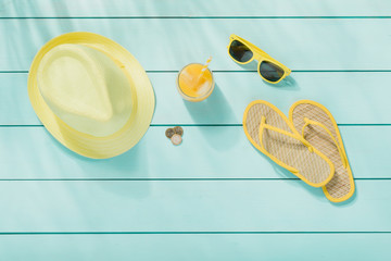 Summer accessories on wooden background top view