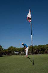 Obraz premium golf player hitting shot at sunny day