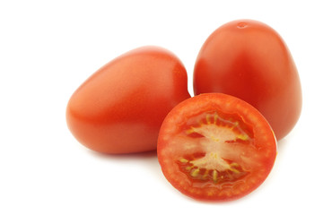 fresh and colorful italian roma tomatoes and a cut half on a white background