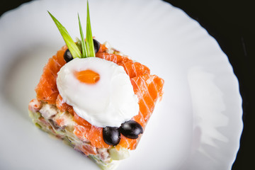 salad with salmon and poached egg, a tasty dish in the restaurant