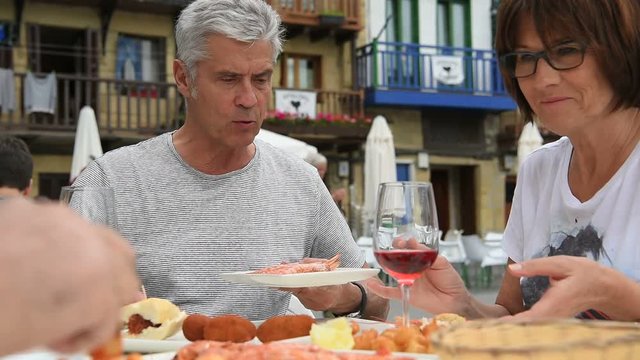 Senior couple eating spanish fingerfood in Spain