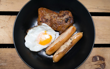 Homemade foods - Chicken fillet grilled steak and egg fried on wooden background
